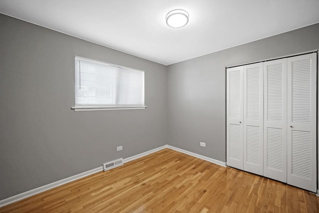 8851 S State St, Chicago, IL 60619 - unfurnished bedroom featuring light wood-type flooring, a closet, and baseboards