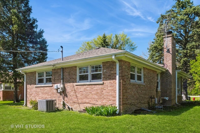 1727 Dundee Rd, Northbrook, IL 60062 - view of side of property with brick siding, a lawn, and a chimney