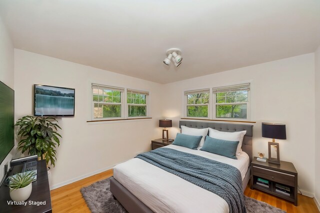 1727 Dundee Rd, Northbrook, IL 60062 - bedroom with multiple windows, wood finished floors, and baseboards