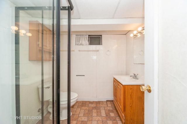 1727 Dundee Rd, Northbrook, IL 60062 - full bathroom featuring toilet, a shower stall, vanity, and tile walls