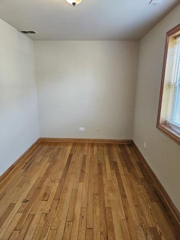 spare room with light wood-type flooring and baseboards