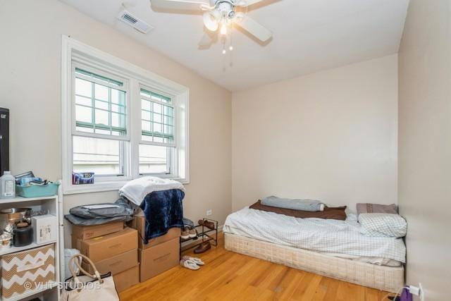 bedroom featuring wood finished floors and a ceiling fan