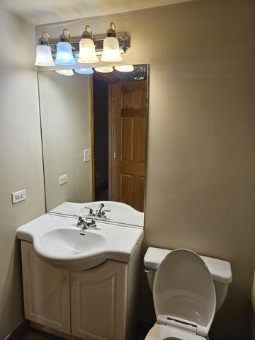 bathroom with toilet and vanity
