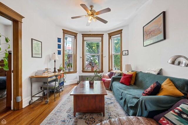 3310 S Lowe St, Chicago, IL 60616 - living room with radiator heating unit, wood finished floors, baseboards, and a ceiling fan