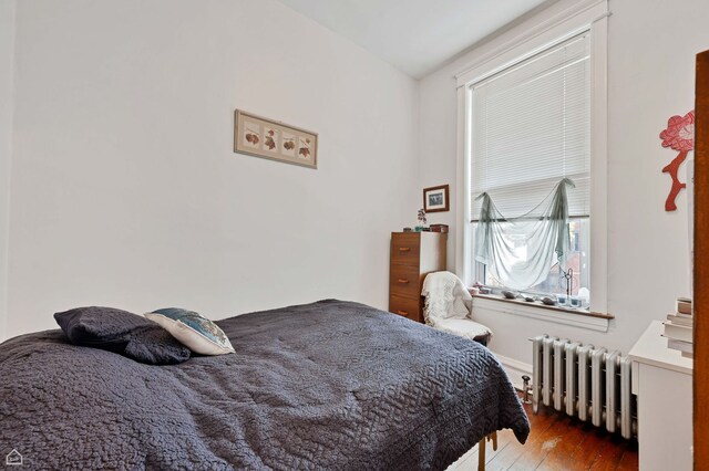 3310 S Lowe St, Chicago, IL 60616 - bedroom with radiator heating unit and hardwood / wood-style floors