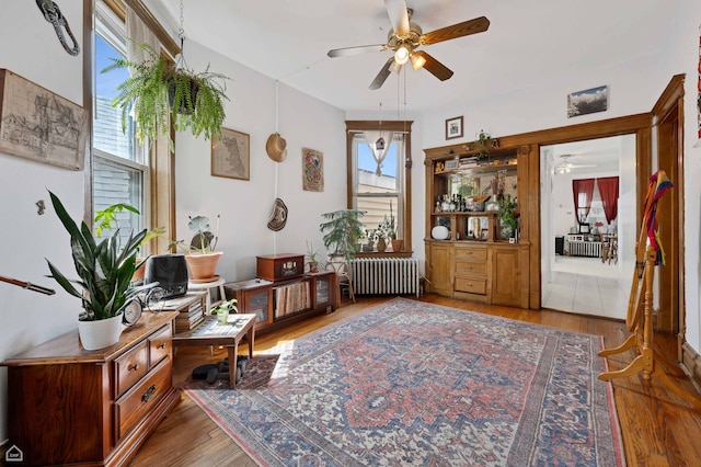 3310 S Lowe St, Chicago, IL 60616 - sitting room featuring radiator, a ceiling fan, and wood finished floors