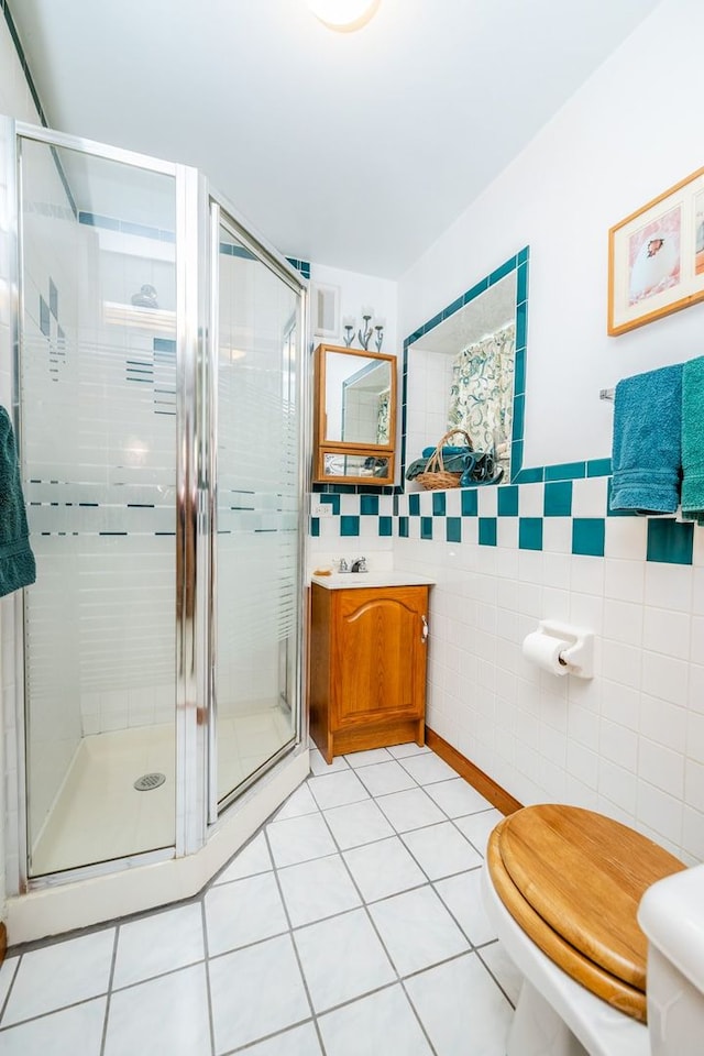 3730 Wenonah Ave, Berwyn, IL 60402 - full bathroom with tile walls, toilet, a stall shower, tile patterned floors, and vanity