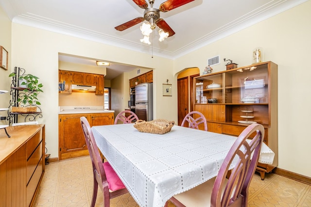 3730 Wenonah Ave, Berwyn, IL 60402 - dining room featuring arched walkways, ceiling fan, crown molding, light tile patterned floors, and baseboards