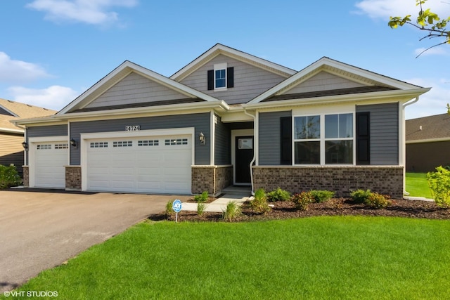 craftsman inspired home featuring a front lawn, brick siding, concrete driveway, and an attached garage