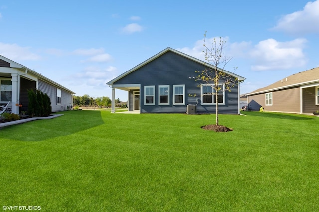 rear view of property with a lawn