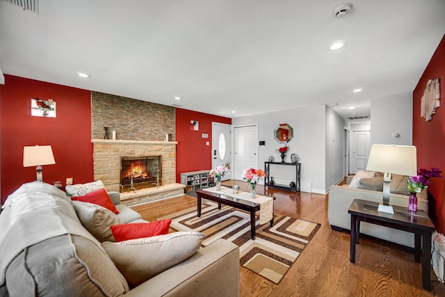 1636 S 14th Ave, Maywood, IL 60153 - living area with wood finished floors, recessed lighting, a stone fireplace, an accent wall, and baseboards