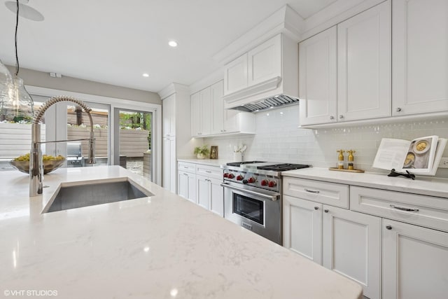 1048 W Webster Ave, Chicago, IL 60614 - kitchen with premium stove, a sink, tasteful backsplash, white cabinetry, and recessed lighting