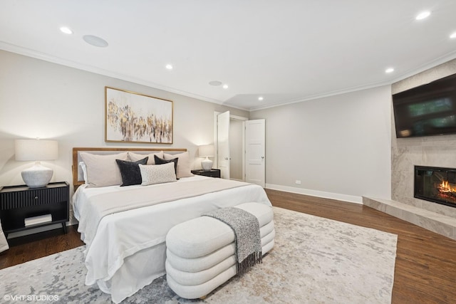 1048 W Webster Ave, Chicago, IL 60614 - bedroom featuring ornamental molding, recessed lighting, wood finished floors, baseboards, and a premium fireplace