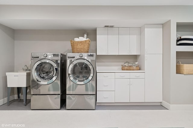 1048 W Webster Ave, Chicago, IL 60614 - laundry area featuring cabinet space, separate washer and dryer, and baseboards