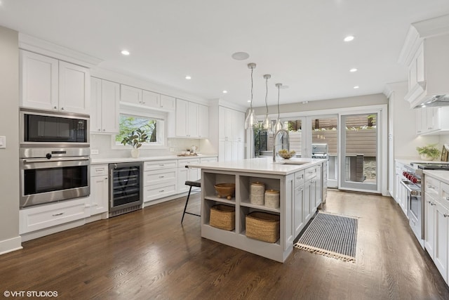 1048 W Webster Ave, Chicago, IL 60614 - kitchen featuring stainless steel appliances, wine cooler, a sink, light countertops, and recessed lighting