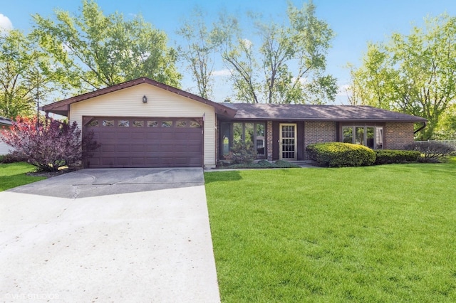1179 Pegwood Dr, Elgin, IL 60120 - ranch-style house with a garage, a front yard, driveway, and brick siding