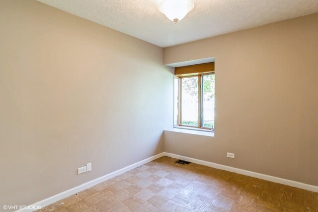 1179 Pegwood Dr, Elgin, IL 60120 - unfurnished room with baseboards and a textured ceiling