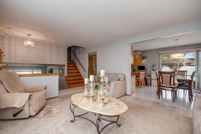 living area featuring stairs, light colored carpet, and baseboards