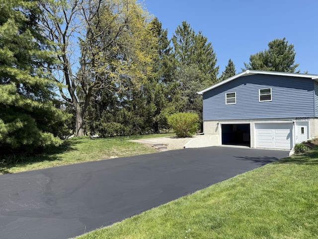 11 S Roberts Rd, Inverness, IL 60067 - view of side of property with asphalt driveway, a garage, and a lawn