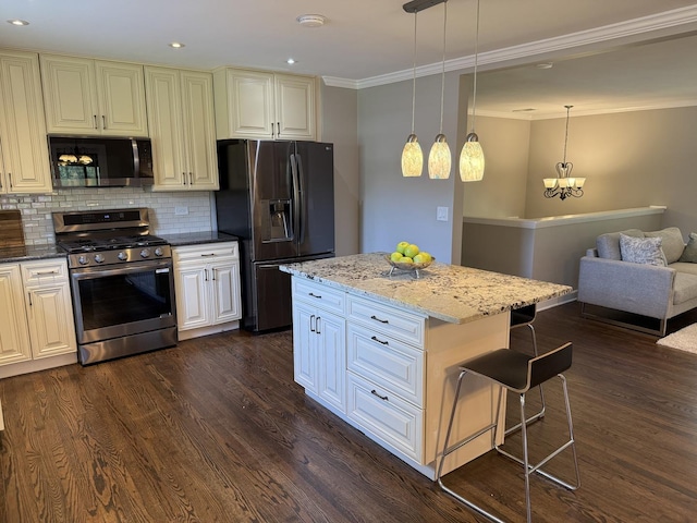 11 S Roberts Rd, Inverness, IL 60067 - kitchen featuring appliances with stainless steel finishes, a breakfast bar area, ornamental molding, dark wood-type flooring, and backsplash