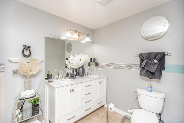 bathroom with toilet and double vanity