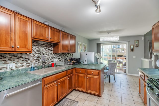 kitchen with appliances with stainless steel finishes, a sink, tasteful backsplash, and brown cabinets