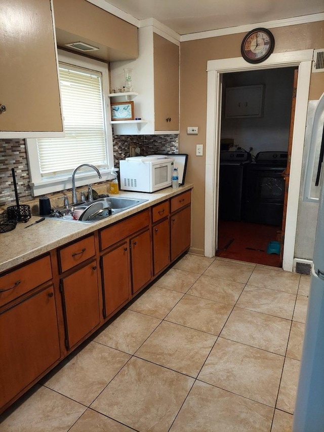 14636 Clark St, Dolton, IL 60419 - kitchen with white microwave, a sink, backsplash, light countertops, and open shelves