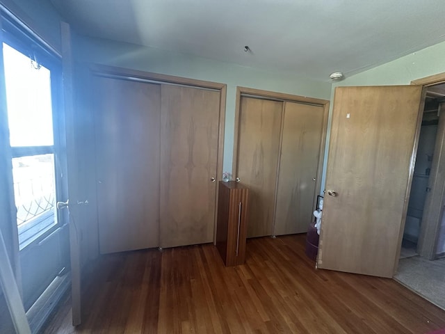 16 King Arthur Ct Unit 16, Northlake, IL 60164 - unfurnished bedroom featuring two closets and wood finished floors