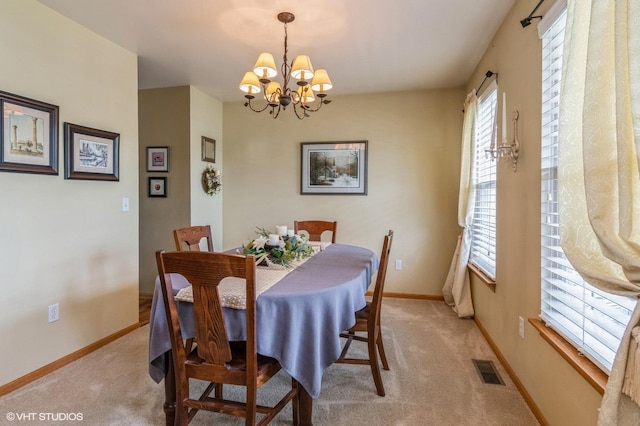 1722 John St, Yorkville, IL 60560 - dining room with a chandelier, light carpet, and baseboards