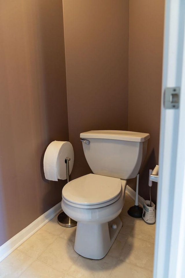bathroom featuring toilet and baseboards