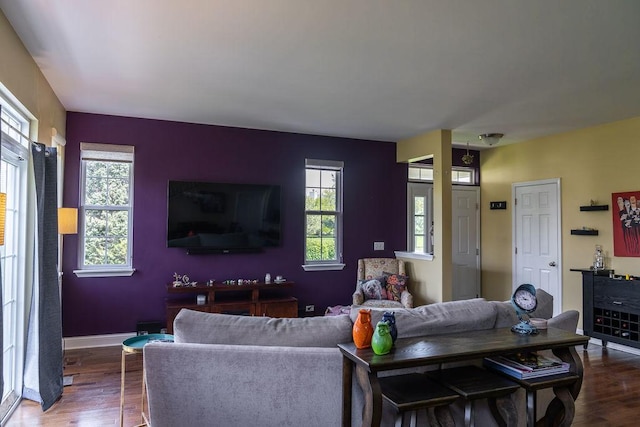 living area with wood finished floors and baseboards