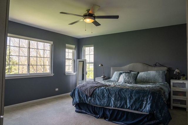carpeted bedroom with baseboards and a ceiling fan