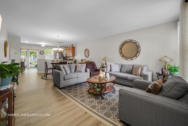 1677 Brightwood Pl Unit 8B, Aurora, IL 60506 - living room featuring a chandelier and light wood-style flooring