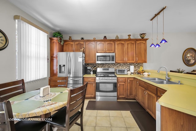 1677 Brightwood Pl Unit 8B, Aurora, IL 60506 - kitchen with appliances with stainless steel finishes, a sink, healthy amount of natural light, and a peninsula