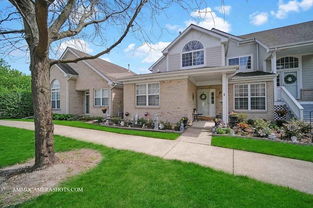1677 Brightwood Pl Unit 8B, Aurora, IL 60506 - traditional-style home featuring brick siding and a front lawn
