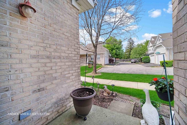 1677 Brightwood Pl Unit 8B, Aurora, IL 60506 - view of patio featuring a garage