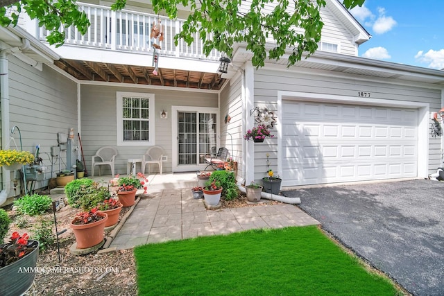 1677 Brightwood Pl Unit 8B, Aurora, IL 60506 - property entrance with asphalt driveway, a balcony, and a garage
