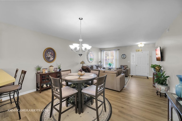 1677 Brightwood Pl Unit 8B, Aurora, IL 60506 - dining space featuring light wood finished floors, a chandelier, and baseboards