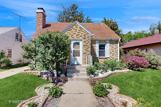 6 N Melrose Ave, Elgin, IL 60123 - view of front of house with a front yard, a chimney, and a shingled roof