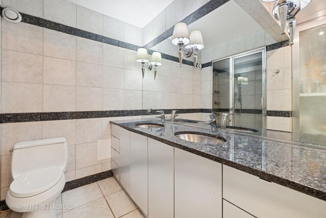 1122 N Clark St Unit 3301-10, Chicago, IL 60610 - full bath with tile walls, double vanity, a shower stall, and tile patterned floors