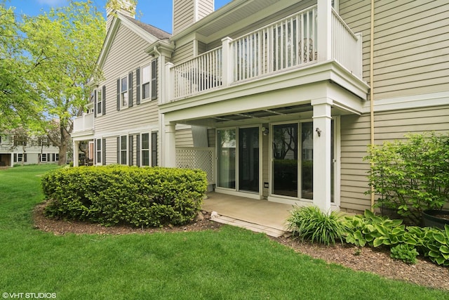 708 Newgate Ln Unit A, Prospect Heights, IL 60070 - rear view of property with a balcony, a chimney, and a lawn