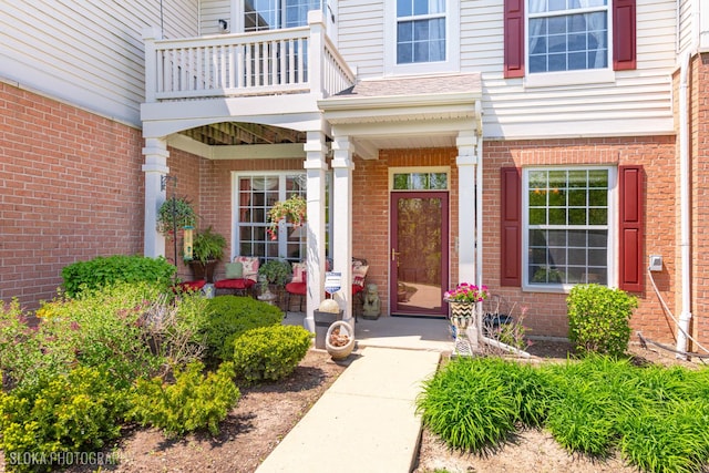 2253 Concord Dr, Mchenry, IL 60050 - property entrance with a balcony, brick siding, and a porch