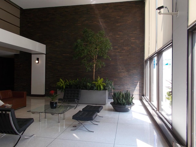 5455 N Sheridan Rd Unit 408, Chicago, IL 60640 - common area featuring a high ceiling and brick wall