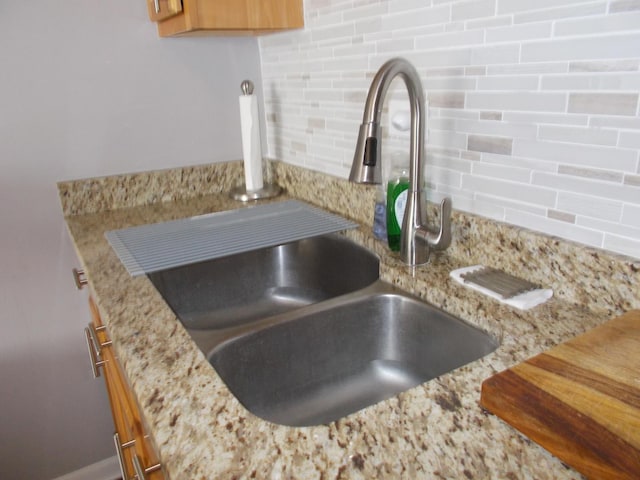 5455 N Sheridan Rd Unit 408, Chicago, IL 60640 - kitchen view of a sink, backsplash, and light stone counters
