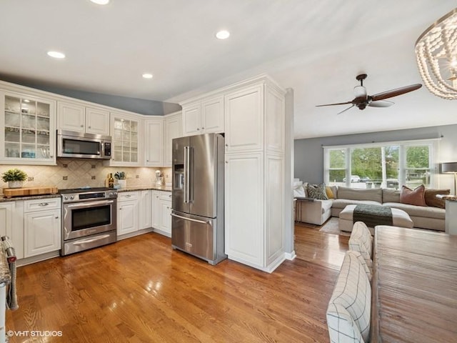 1811 Maplewood Ct, Lindenhurst, IL 60046 - kitchen with stainless steel appliances, open floor plan, wood finished floors, white cabinets, and recessed lighting