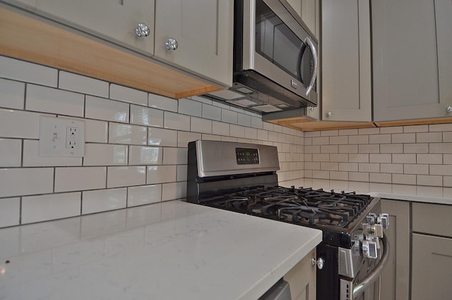 2573 State Route 17th Hwy, Toluca, IL 61369 - kitchen featuring stainless steel appliances, gray cabinetry, and backsplash