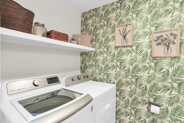 clothes washing area featuring wallpapered walls and washer and clothes dryer
