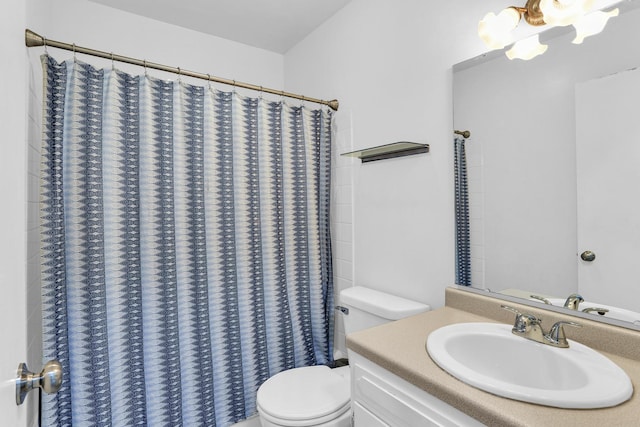 bathroom featuring toilet, vanity, and a shower with shower curtain
