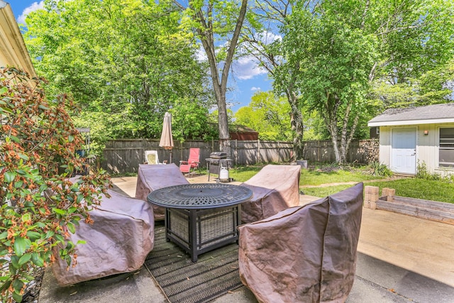 deck with a fenced backyard, outdoor dining area, and an outbuilding