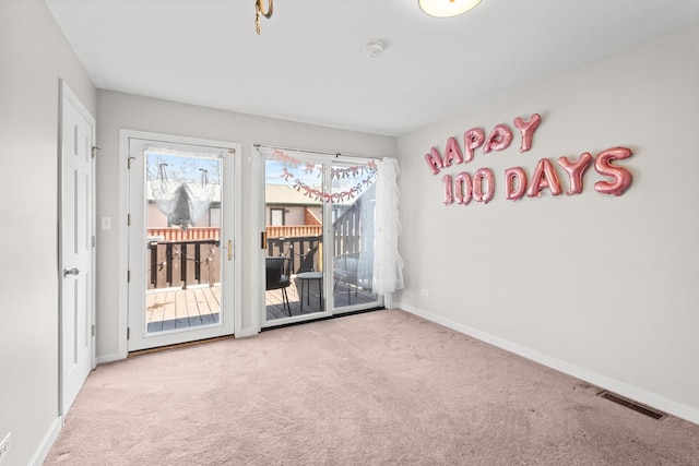 spare room featuring carpet floors and baseboards
